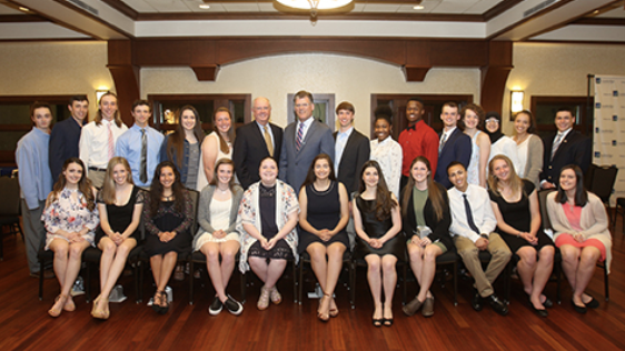 A group of scholarship recipients and FBO employees posing for the camera at an event